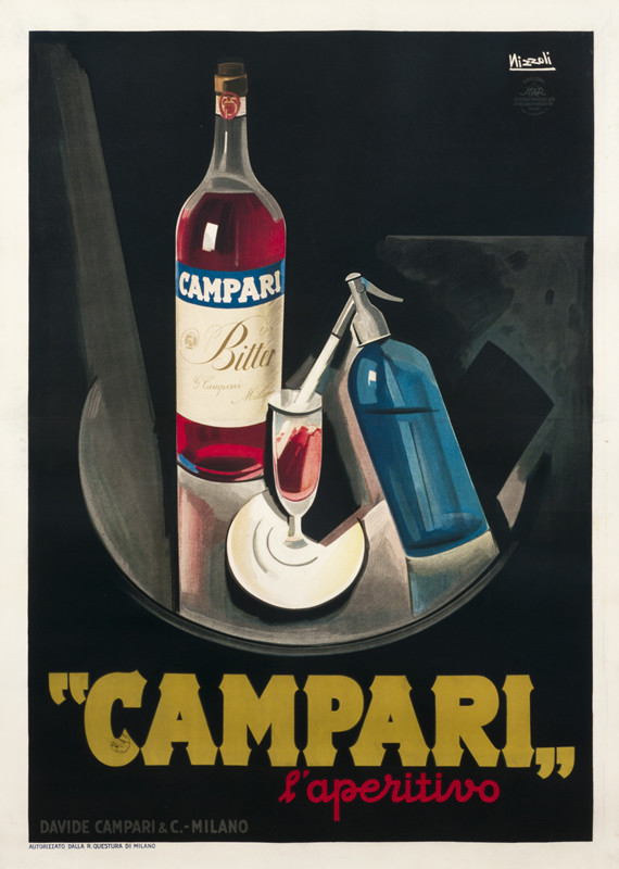 Still life with Campari bottle and seltzer bottle spraying into glass; black, red, blue, yellow
