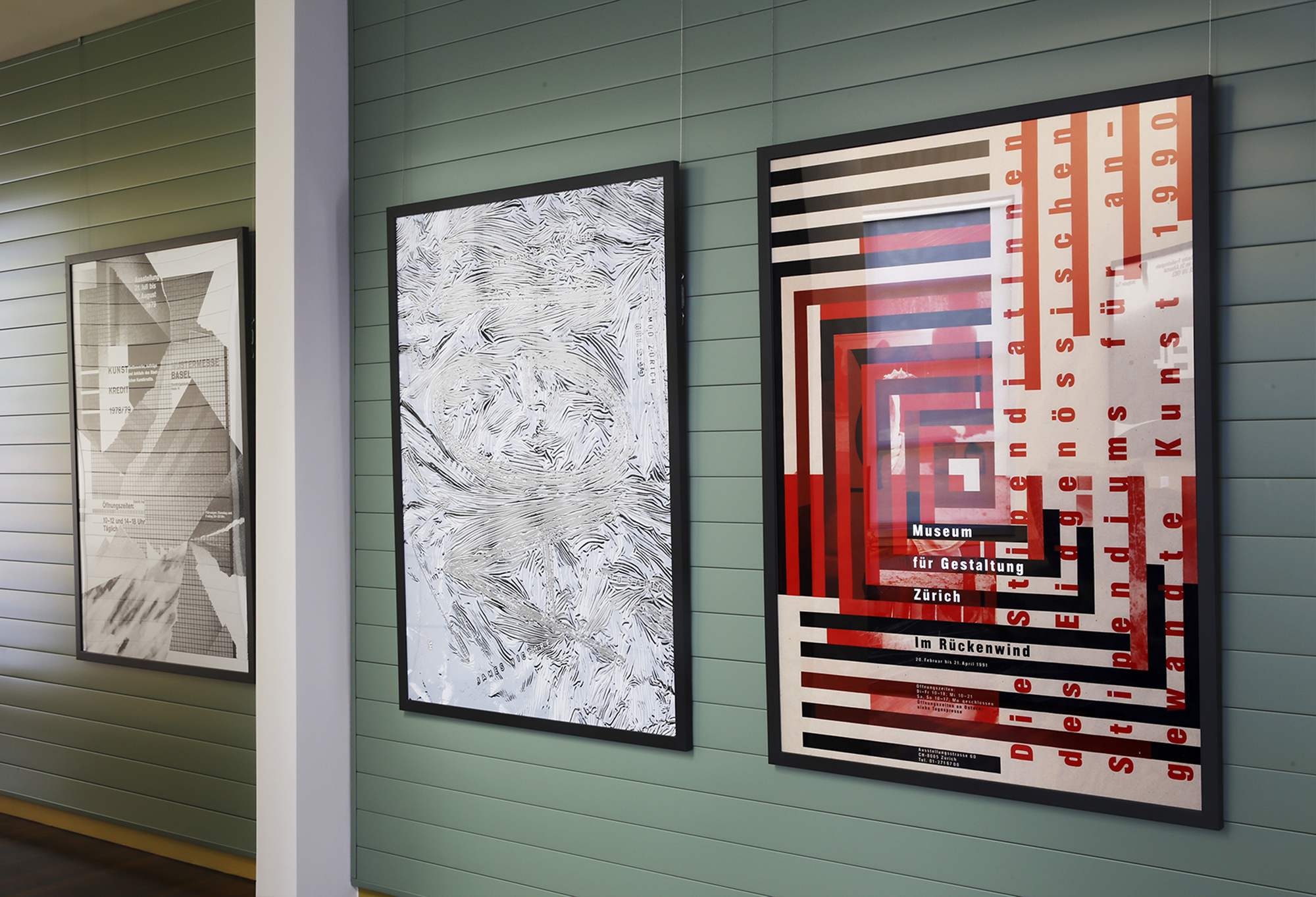 Typographic posters on wall; red, grey, black, green