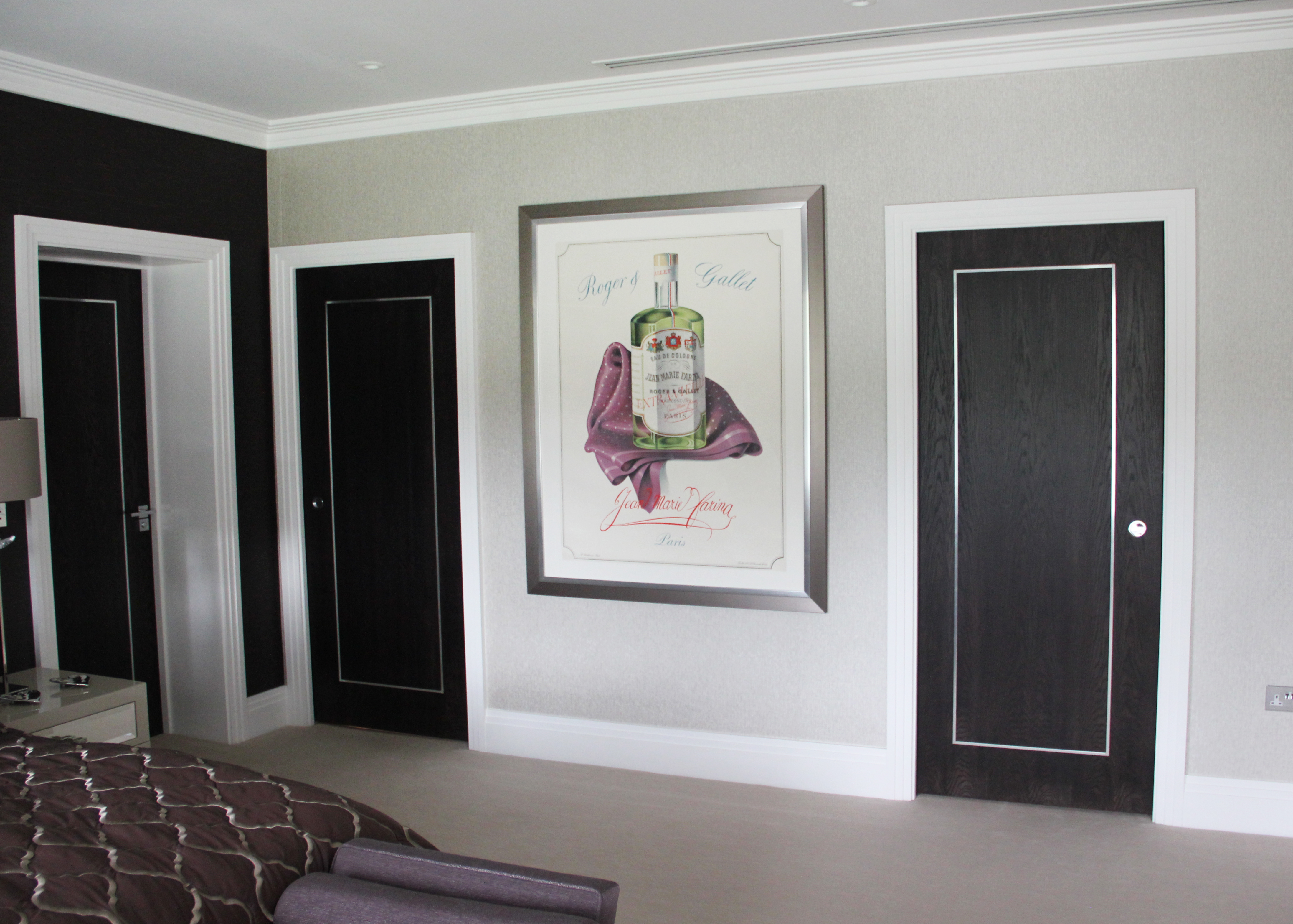 framed beverage poster between two doors; black, white, silver, gray